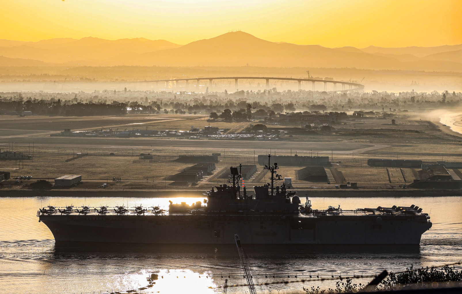 Photo of the USS Tripoli pulling into port near San Diego, California.